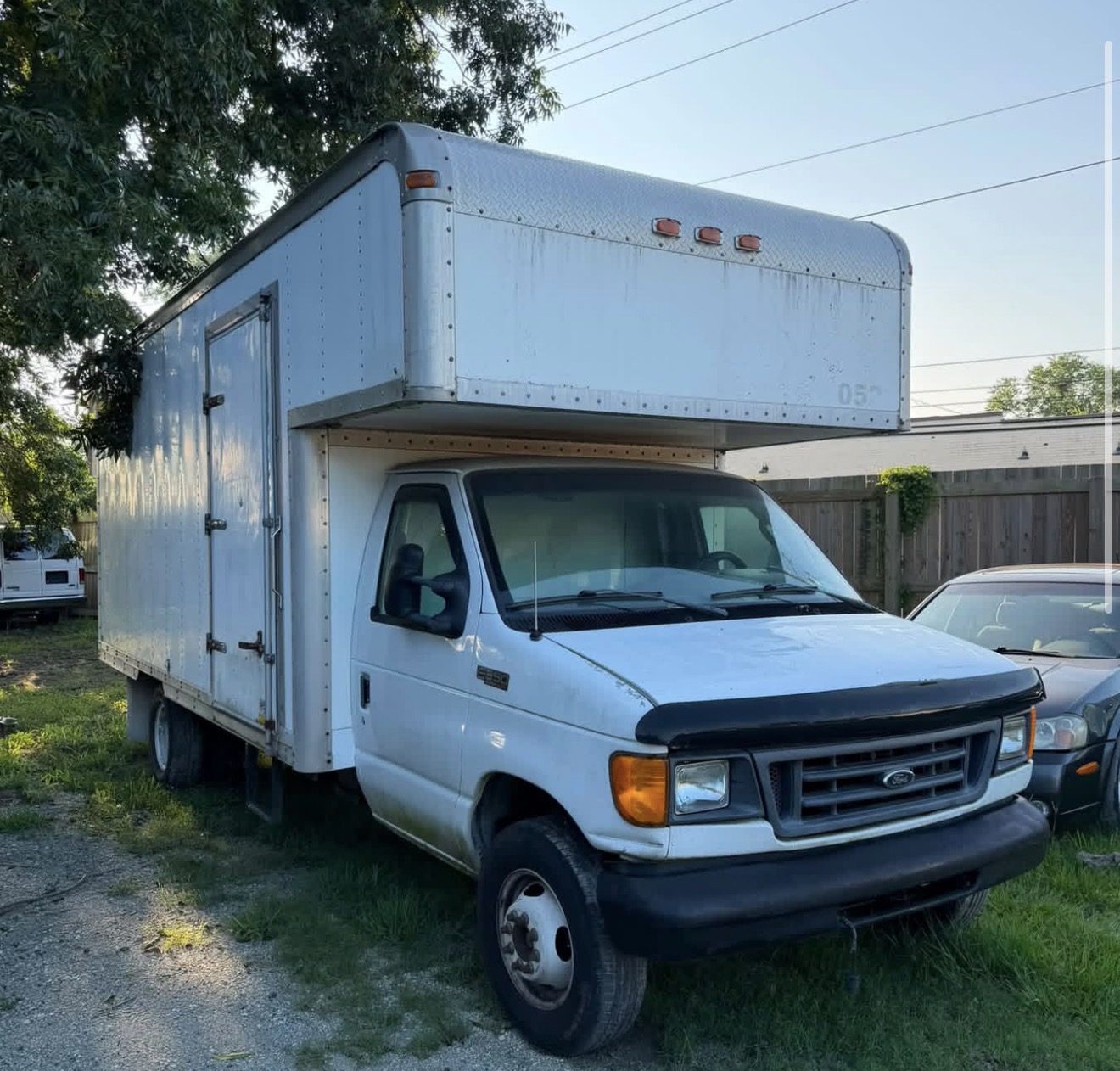 The Wish Ever After box truck as purchased, a white Ford E-series parked under a tree in New Bern, before the wrap